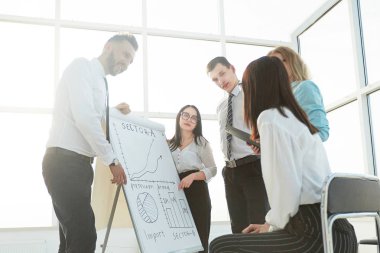 iş ekibinden flipchart ve fikirlerini tartışmak yanında ayakta.