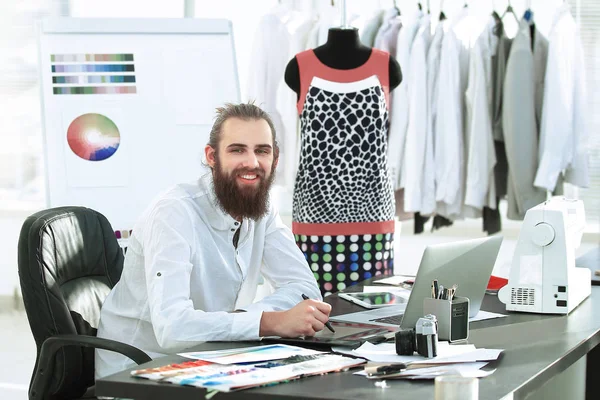 successful designer working on new sketches of clothes