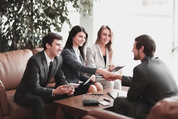 Handshake of business partners over a Desk in a modern office. — Stock Photo, Image