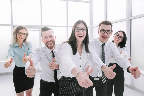 Fun business team showing their thumbs up. — Stock Photo, Image