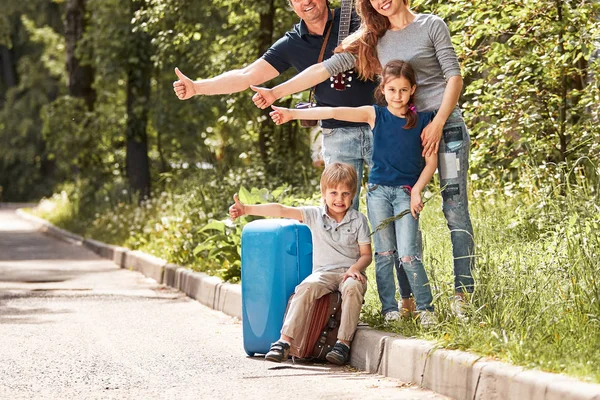 Glada familje röster stående på sidan av vägen — Stockfoto