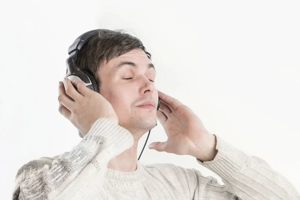 Close seup.modern boy listening to music through headphones . — стоковое фото