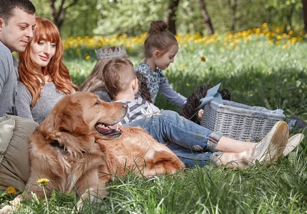 happy family with pet on picnic in summer day.