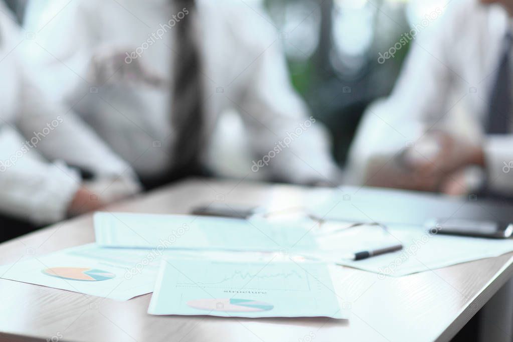 background image. closeup of a table with documents and business team.
