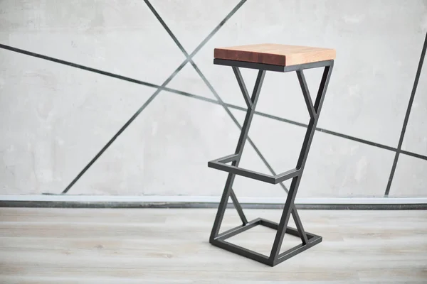 high bar stool made of wood and metal.