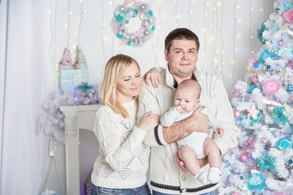 Happy family standing by the Christmas tree — Stock Photo, Image