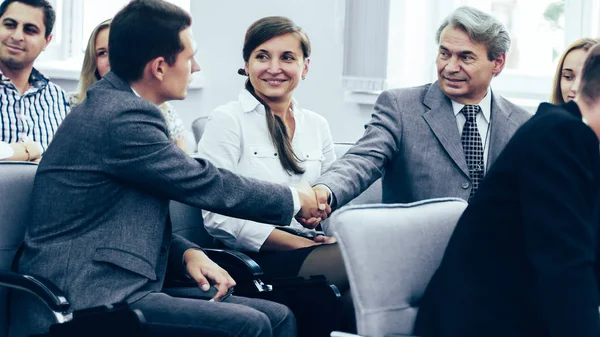 Business partners shake hands in the conference room — Stock Photo, Image