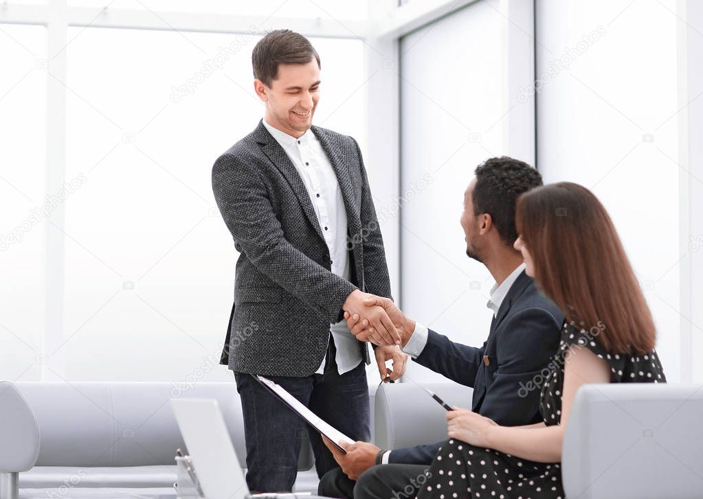 Happy mature couple giving doctor a handshake stock photo