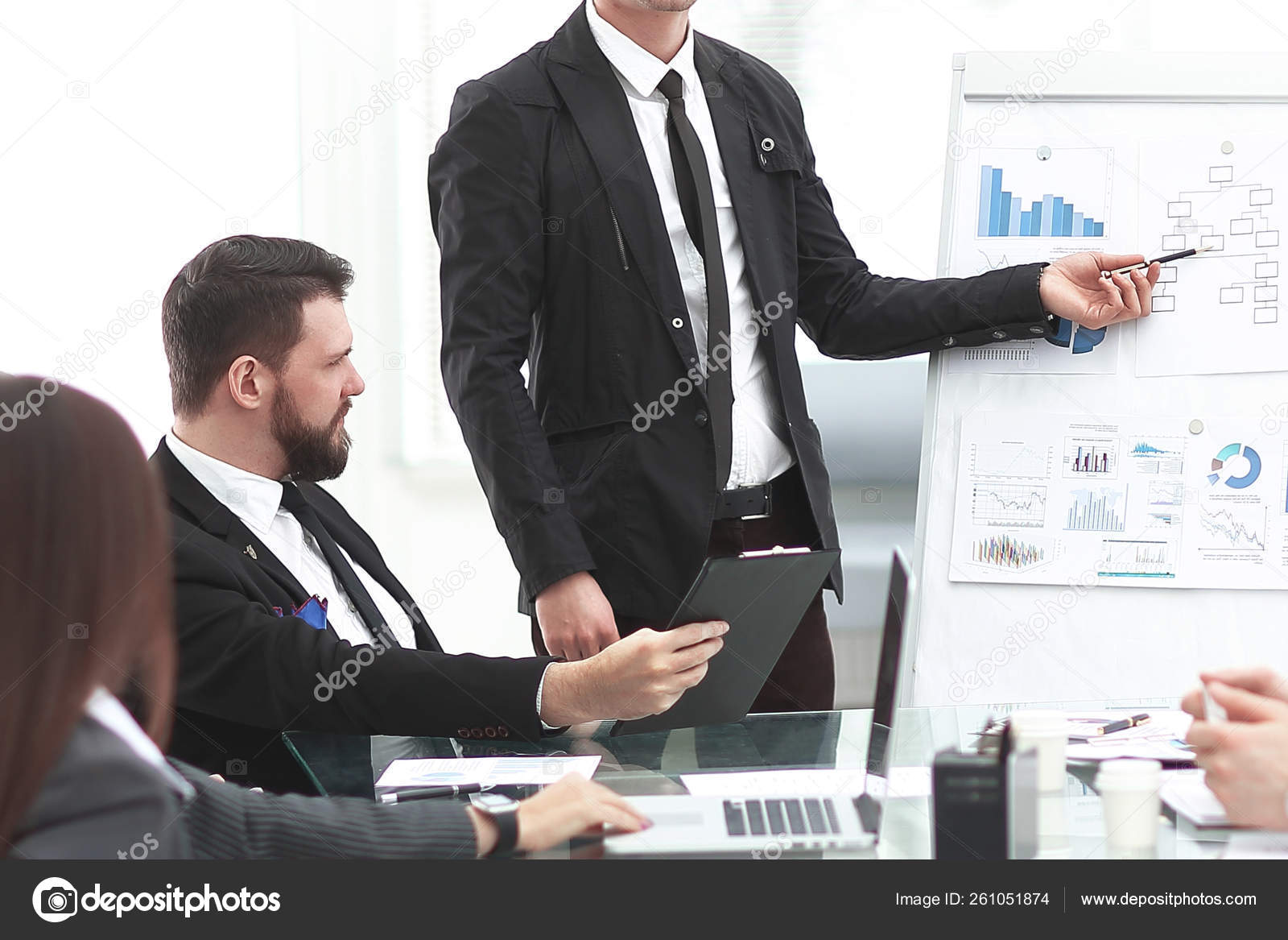 Finance Manager pointing a marker on the flipchart with financial data