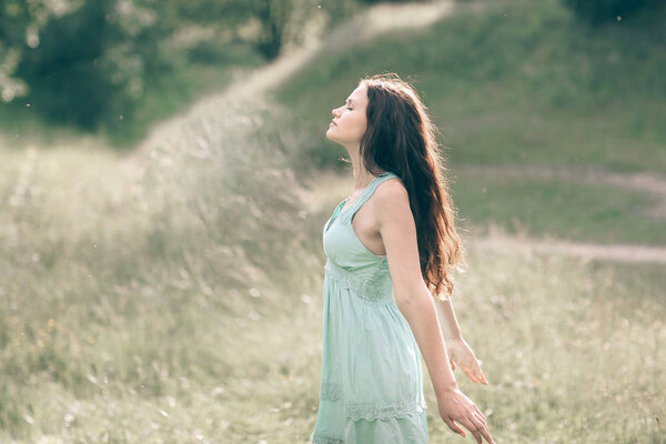 Charming girl exposing her face to the fresh wind . photo with copy space