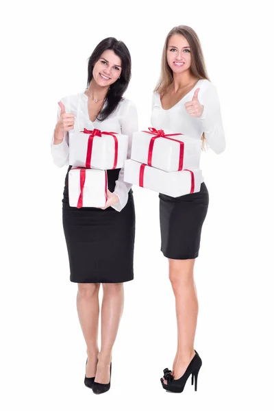 Two young women with gift boxes showing thumbs up — Stock Photo, Image