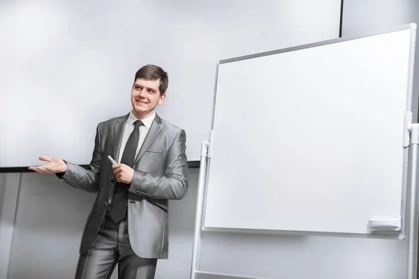 confident businessman standing on stage in the conference hall