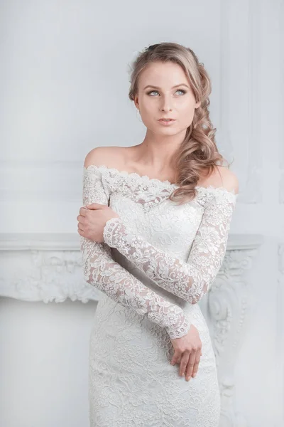 Smiling happy bride trying on wedding dress — Stock Photo, Image