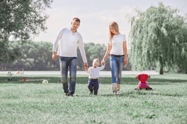 Anne, baba ve küçük oğulları için yaz parkta bir yürüyüş ile oynamak.