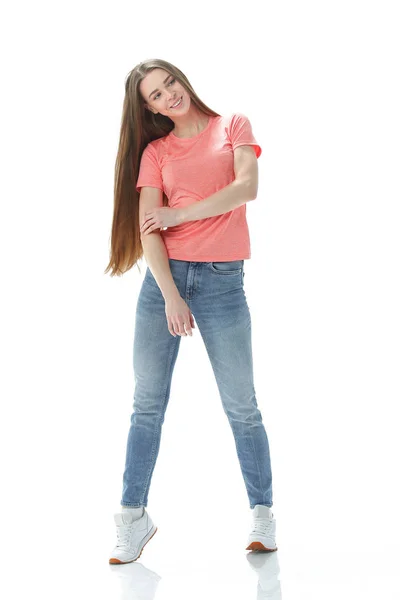 Young woman in jeans and t-shirt goes forward.isolated on white — Stock Photo, Image