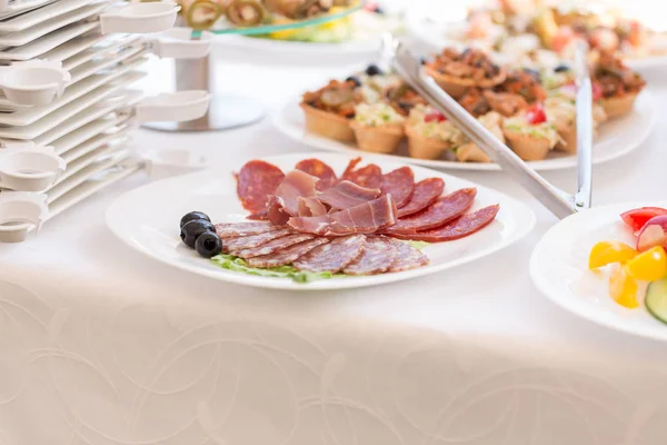 Slices of salami and meat on the festival table — Stock Photo, Image