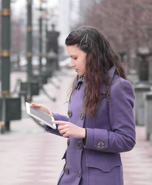 Smiling woman using digital tablet standing on city street — Stock Photo, Image