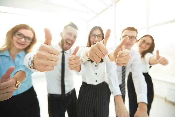 Close up. happy business team showing thumbs up. — Stock Photo, Image