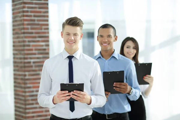 Group of business people with business papers,standing in the office — Stock Photo, Image