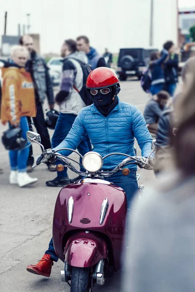 Radfahrer mit Schutzmaske auf einem Motorrad auf einer Straße in der Stadt. — Stockfoto