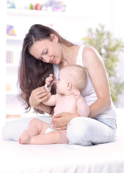 Young mother teaches baby to stand. the concept of motherhood — Stock Photo, Image