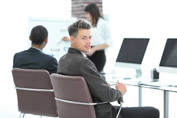 Employee of the company on the background of business team — Stock Photo, Image