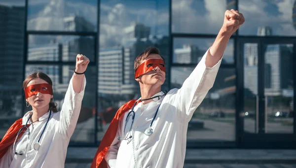 Close up. doctors are superheroes standing on a city street . — Stock Photo, Image