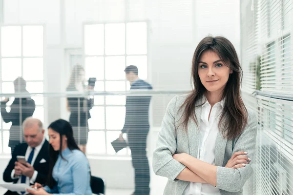 Jonge zakenvrouw staan in een modern kantoor. — Stockfoto