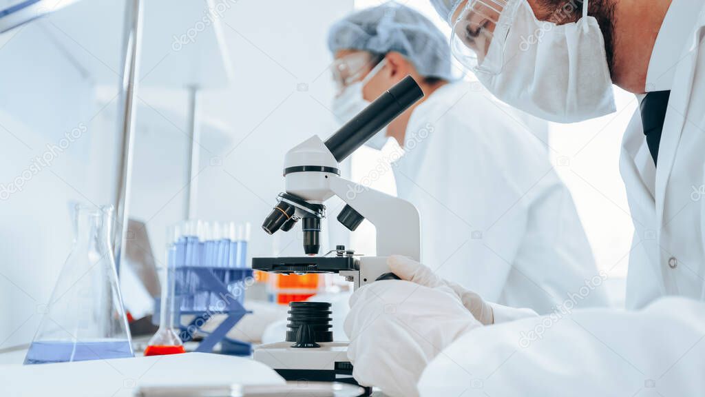 close up. a group of scientists working on creating a new vaccine.