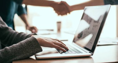 Kapat. Ofisteki iş yerinde bilgisayar kullanan bir çalışan..