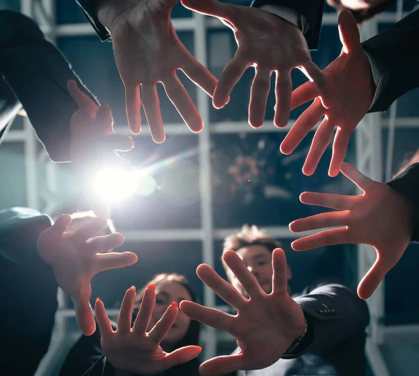 Close up. group of young business people joining their palms in a circle. — Stock Photo, Image