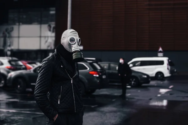 Homem com uma máscara de gás em pé em uma cidade Estacionamento — Fotografia de Stock