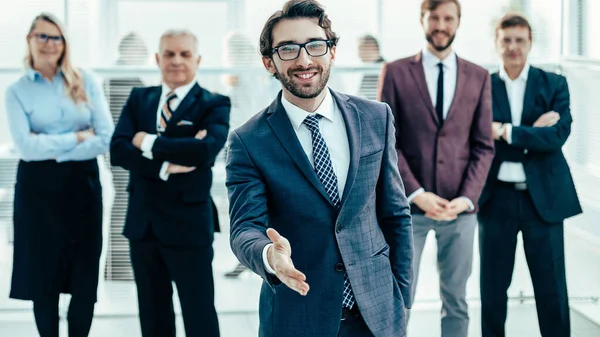 Friendly businessman holding out his hand for a handshake. — Stock Photo, Image