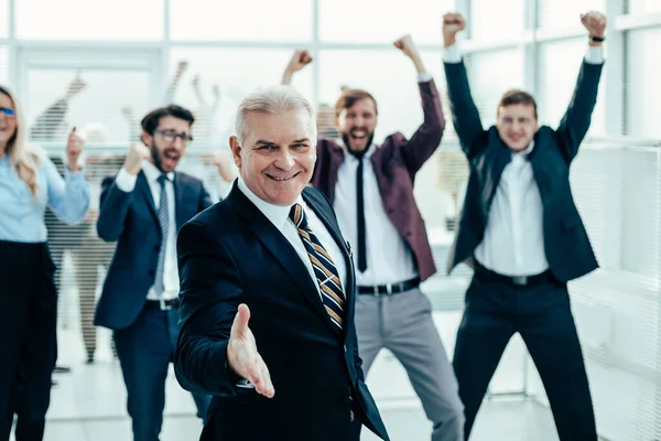 Happy businessman holding out his hand for a handshake. — Stock Photo, Image