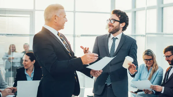 Hoofd en assistent die een werkdocument bespreken — Stockfoto