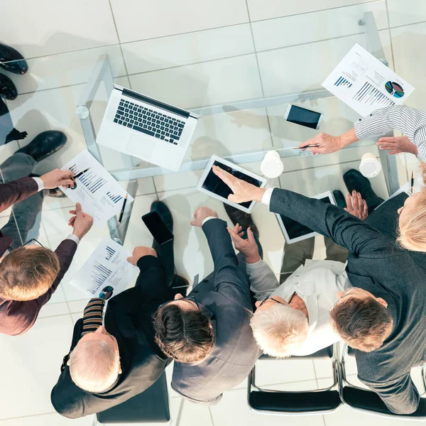 Vista superior. Grupo de empregados a discutir estatísticas financeiras . — Fotografia de Stock