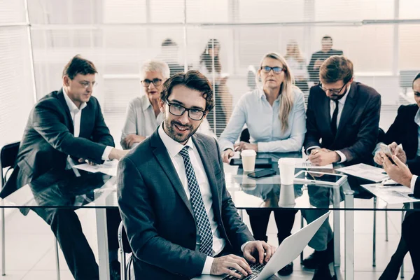 Uomo d'affari fiducioso che lavora su un computer portatile vicino alla scrivania dell'ufficio. — Foto Stock