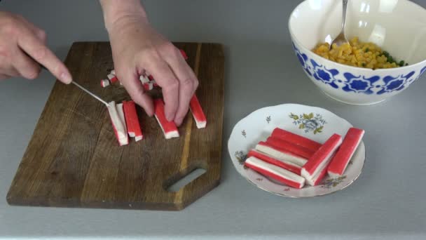 Cutting crab sticks on cutting board in kitchen — Stock Footage Cutting Crab Sticks Cutting Board Kitchen Stock Footage