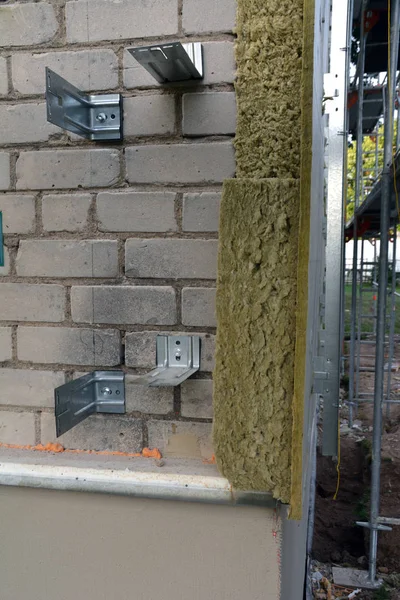 Metal angle for fix mineral wool on brick wall — Stock Photo, Image