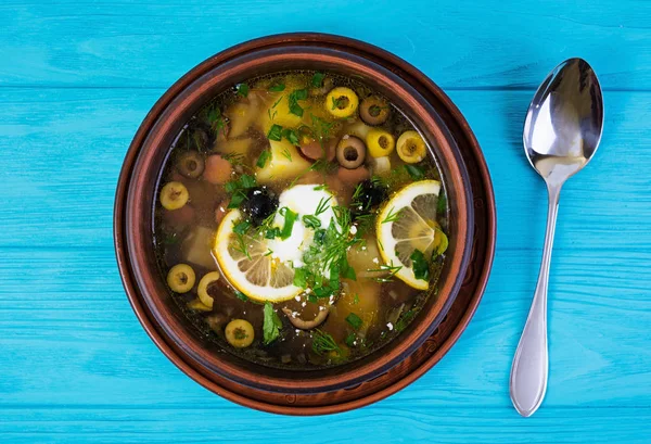 Ahşap zemin üzerine ekşi krema ile Rus çorbası solyanka