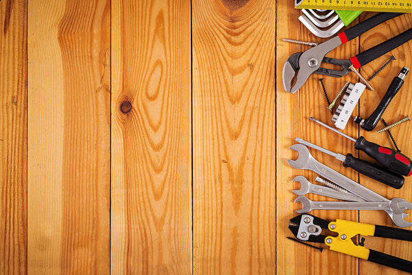 Working tools on wooden rustic background. Top view. Copy space