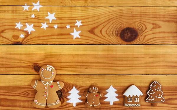 Christmas gingerbread cookies on wooden background