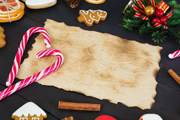 Christmas sweets, ginger cookies on wooden background. Christmas background