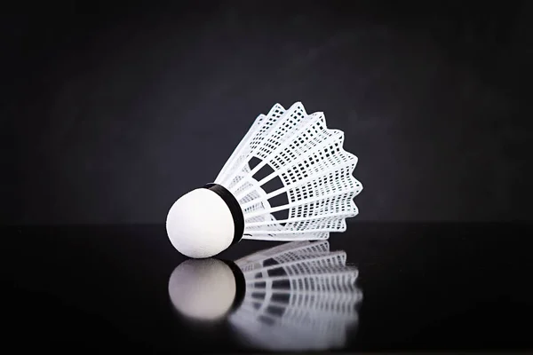 Shuttlecock for badminton isolated on dark background