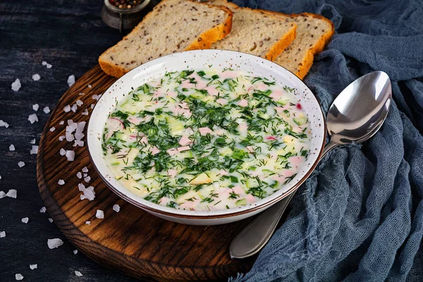 Russian traditional cold soup okroshka. Summer cold soup with yogurt and vegetables.