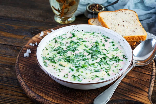 Russian traditional cold soup okroshka. Summer cold soup with yogurt and vegetables.