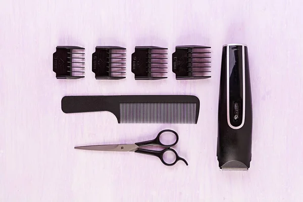 Hairdresser tools on wooden background. Haircut accessories concept. Top view