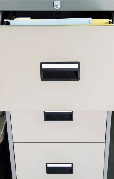 Metal file cabinet with open drawer for searching the private document.