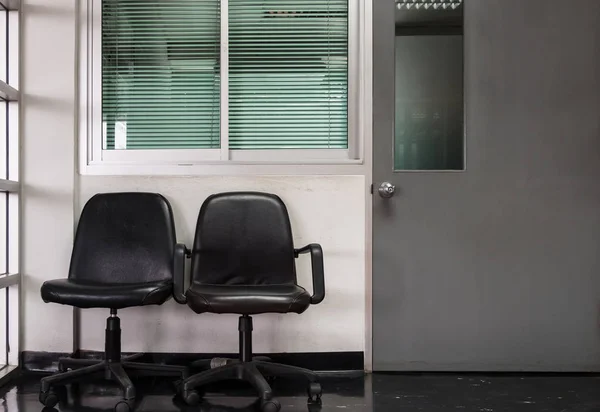 Διπλό Μαύρο Καρέκλα Μπροστά Από Δωμάτιο Του Διευθυντή Του Γραφείου — Φωτογραφία Αρχείου
