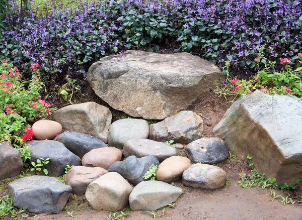 Stone seat in the flower row. — Stock Photo, Image